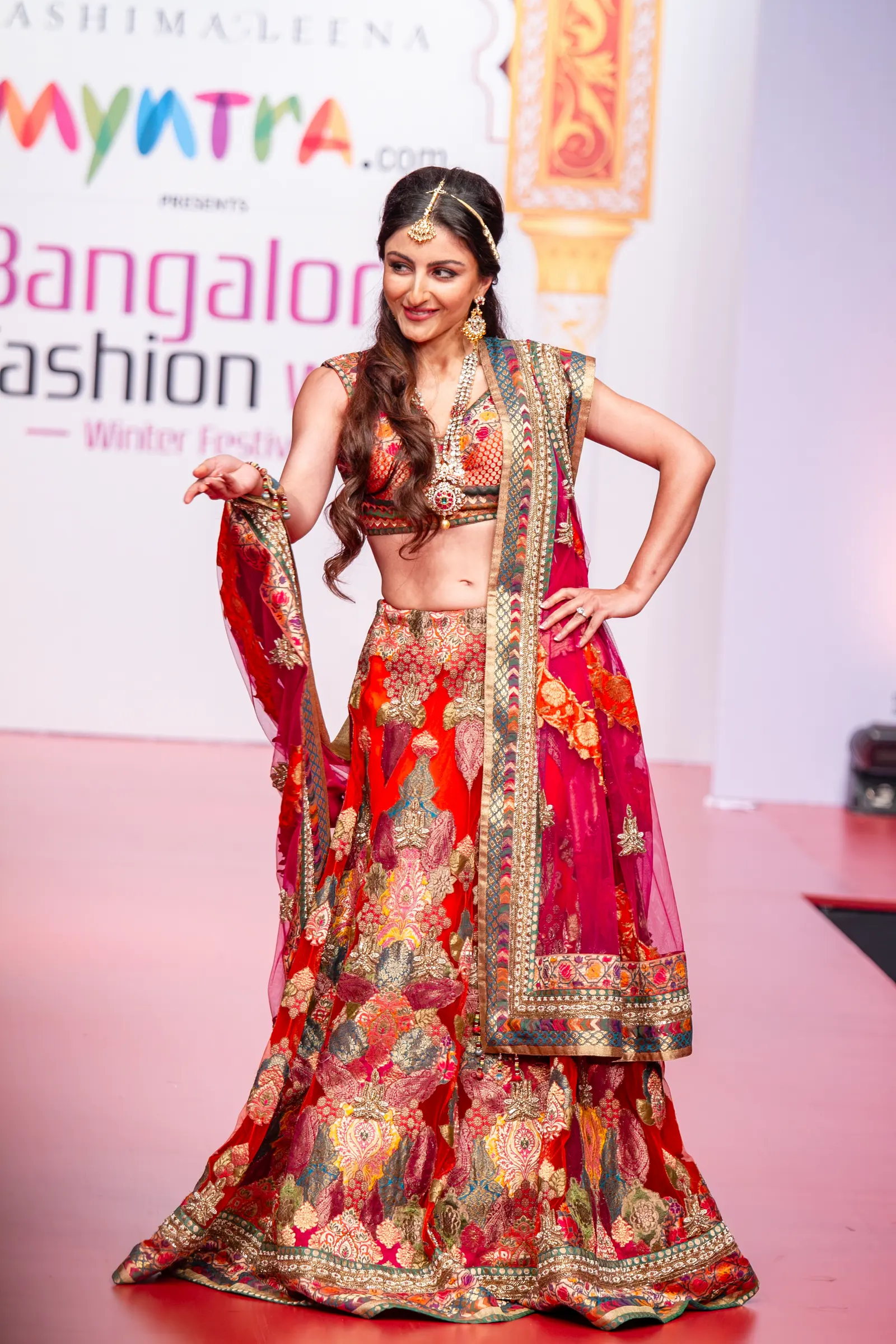 Soha Ali Khan as showstopper in a red and pink embroidered lehenga at Bangalore Fashion Week Winter Festive, photographed by Vivek Pankaj