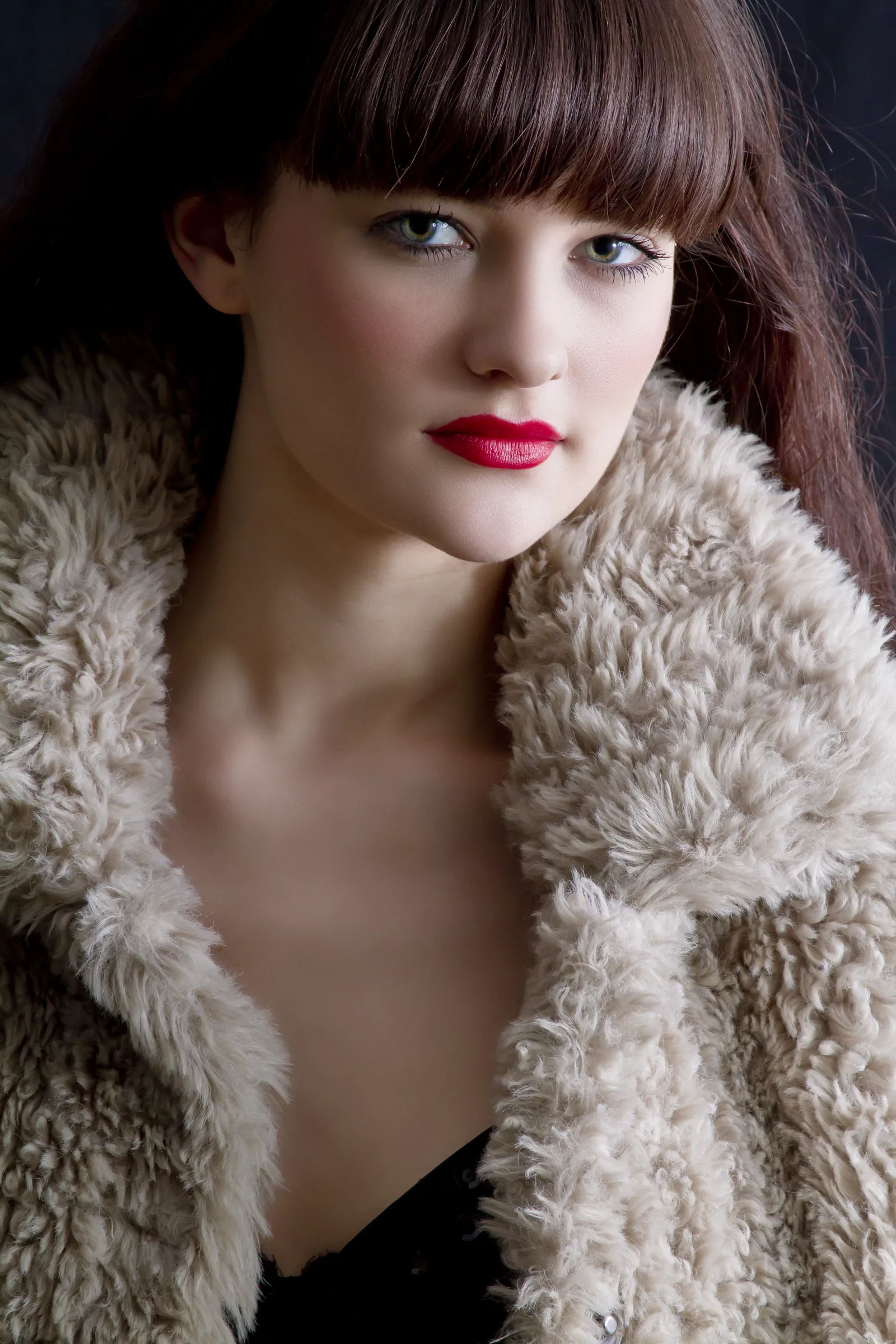 Fashion portrait of a woman with a fringe and red lipstick in a faux-fur coat, by Vivek Pankaj, photographer in Bangalore