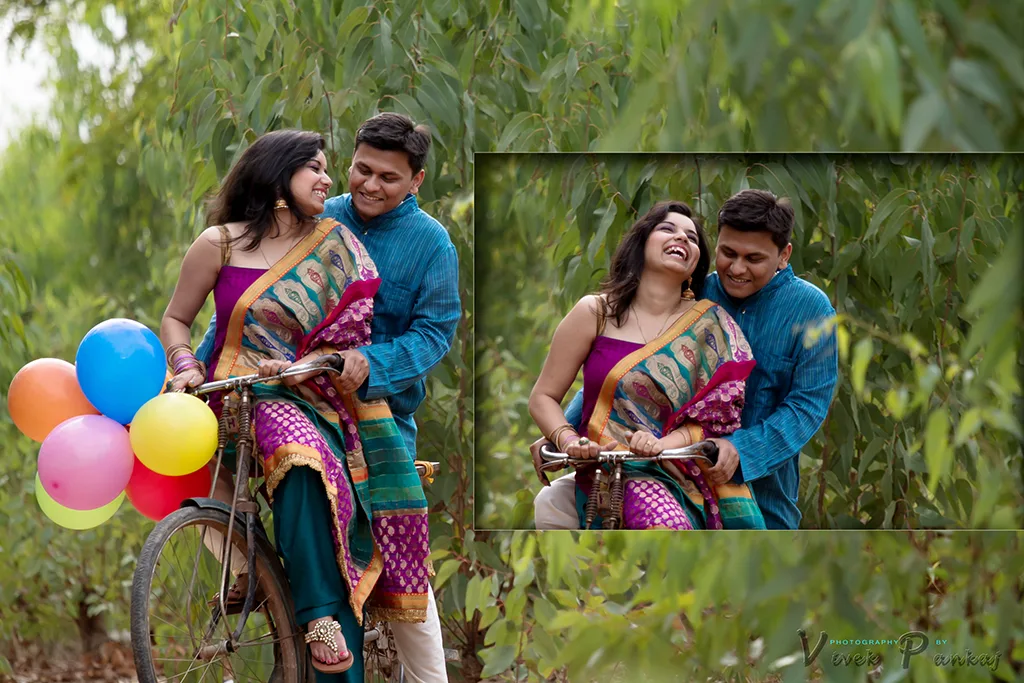 Couple laughing together on a bicycle with colourful balloons among trees during a pre-wedding shoot by Vivek Pankaj